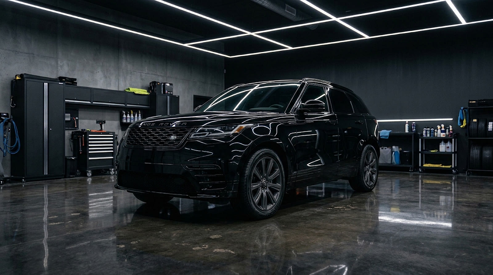 A spotless black SUV under studio light bars