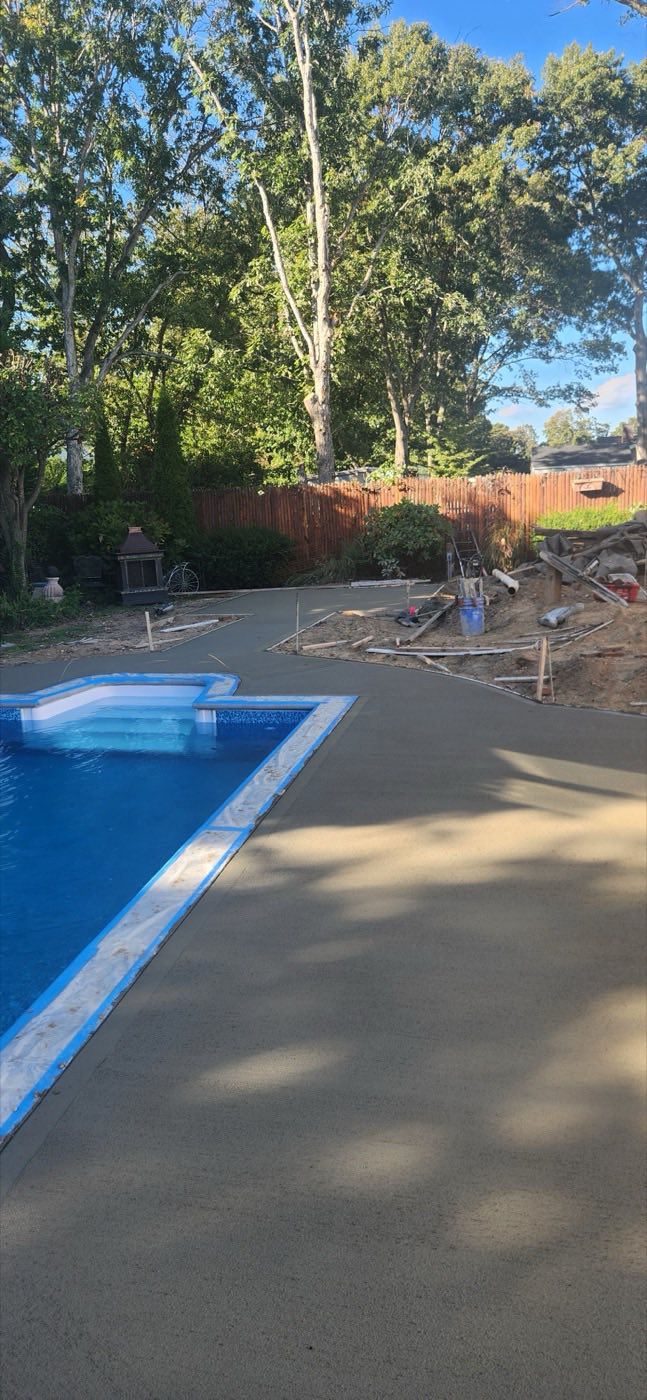 Pool deck and path under tall trees