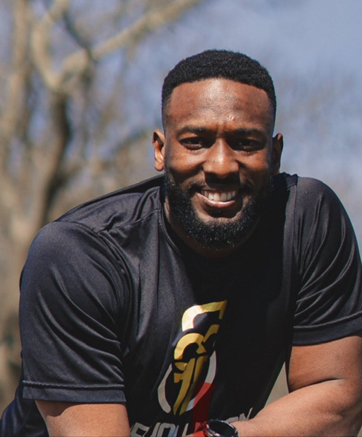 Coach Kyle smiling outdoors in a Forevolution shirt
