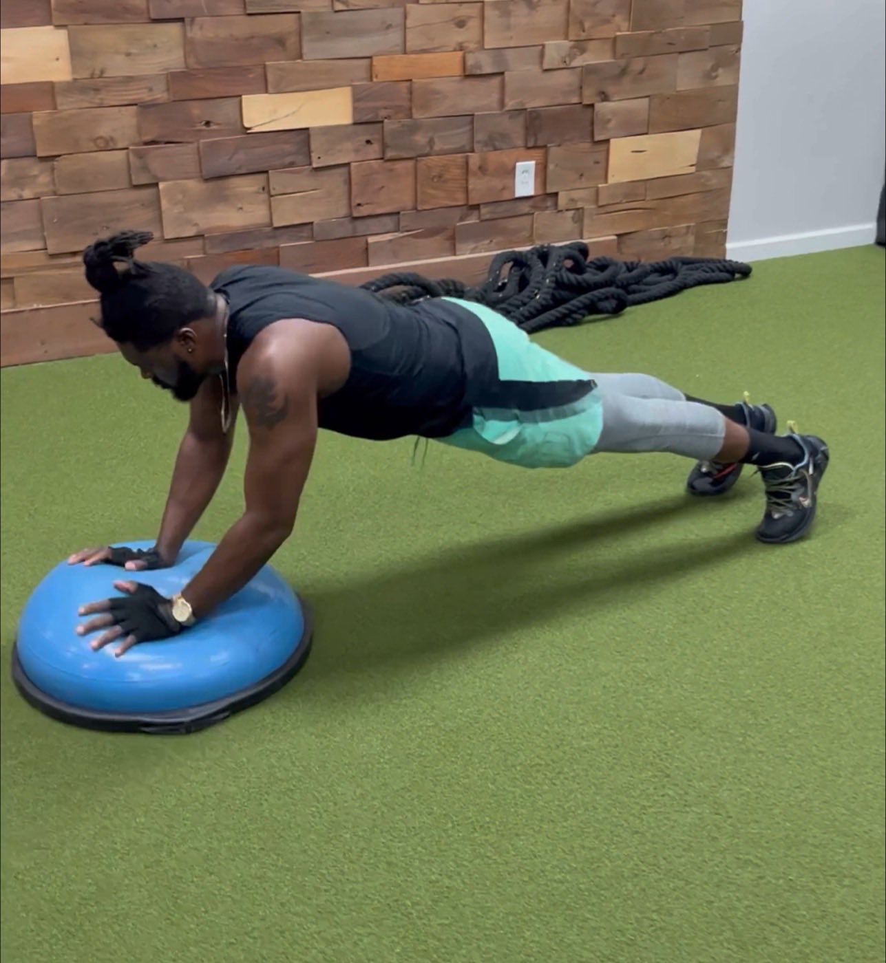 Adult athlete holding a plank on a balance ball